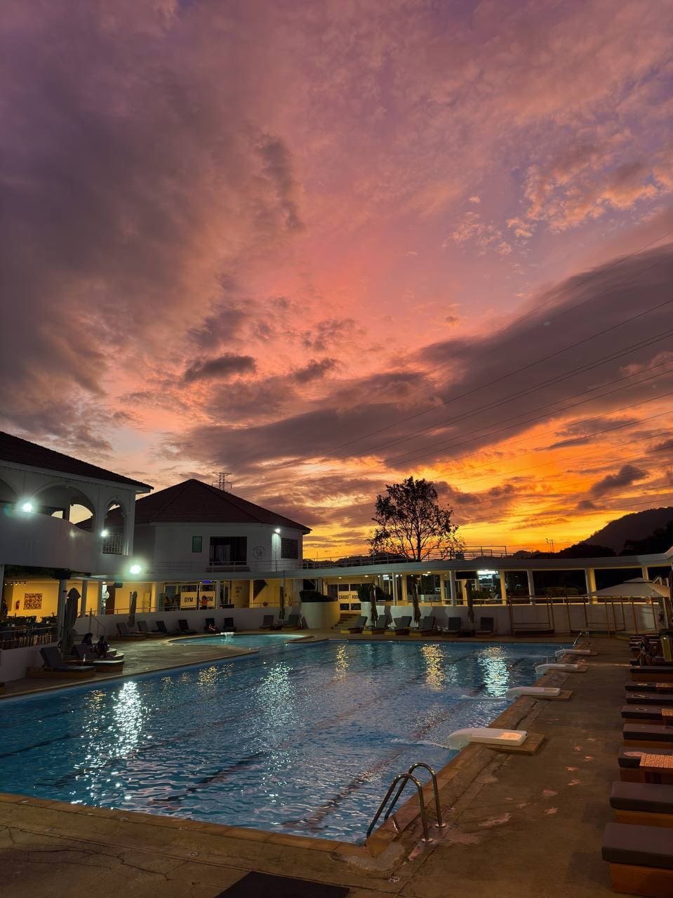 Sunset over the large outdoor pool at KAIF Jungle Club & Spa